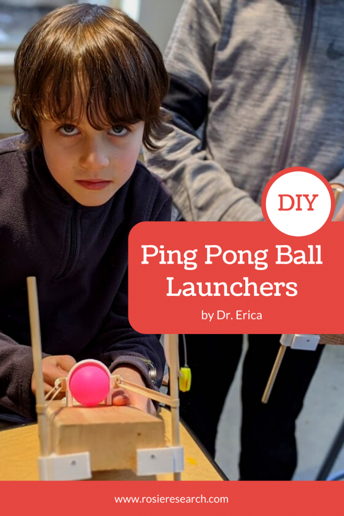 Kid holding ping pong ball launcher